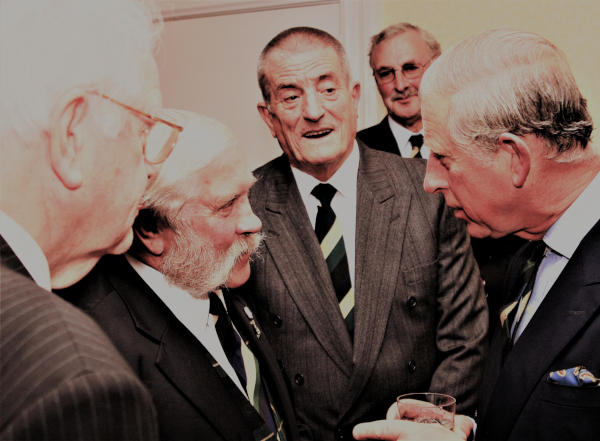 Four suited men with the King