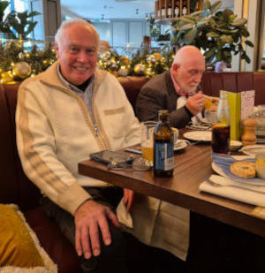 Two men at the end of a restaurant dining tabley