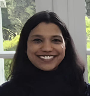 A smiling woman wth long black hair