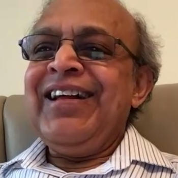 A smiling gentleman wearing glasses