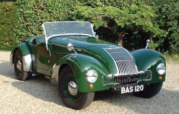 A shiny green 1950s sports car