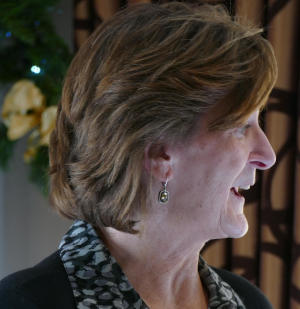 A smiling brown-haired woman looking to the viewer's right