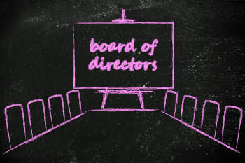 Blackboard with a drawing of a board meeting in pink chalk