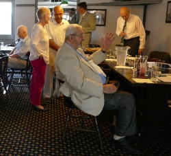 People standing and talking and sitting at tables