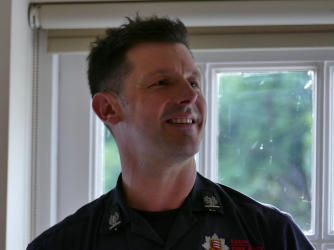 Head and shoulders of a man wearing Fire Service uniform