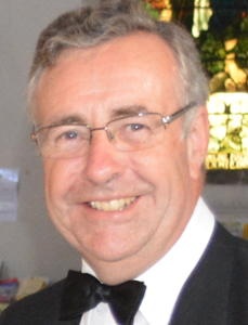 A smiling man in a bow tie
