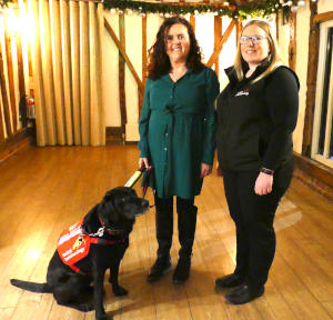 An assistance dog with two ladies