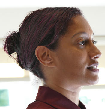 A woman with dark hair tied back in a bun