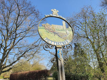 A village sign reading 'Pettistreet'