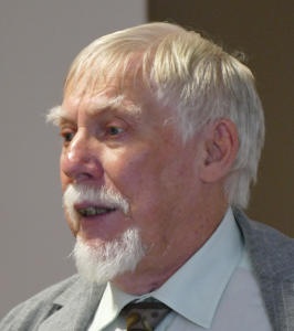 A bearded white-haired man