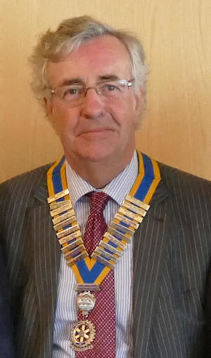 Grey-haired man wearing a President's chain of office