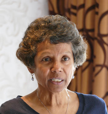 A woman with greying curly hair