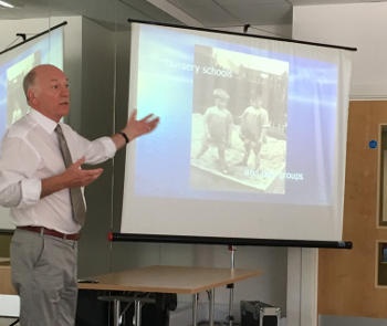 A gentleman giving an onscreen presentation