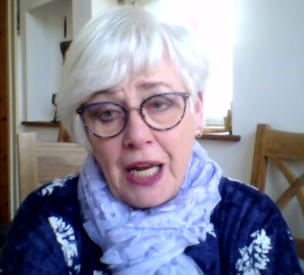 A white-haired lady wearing glasses