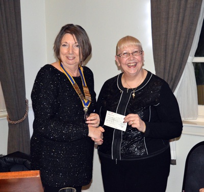 Helen collecting a cheque on behalf of Kirkwood Hospice.