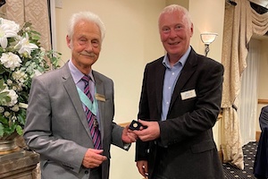 District Governor Chris Brenchley presents Richard Joy with a Paul Harris Fellowship pin