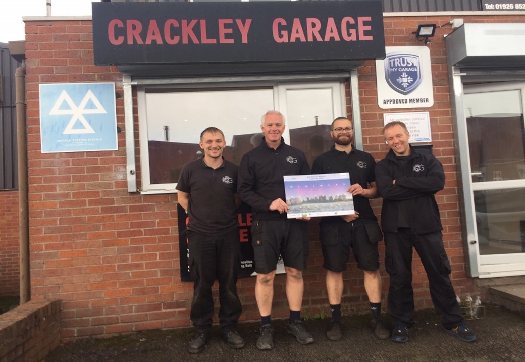 A group of men standing in front of a buildingDescription automatically generated