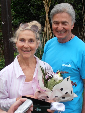 Roger Neuberg and his wife hosting a garden party for the charity Mary's Meals