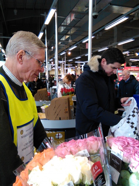 Ian carefully packing a shoppers bags at the checkout