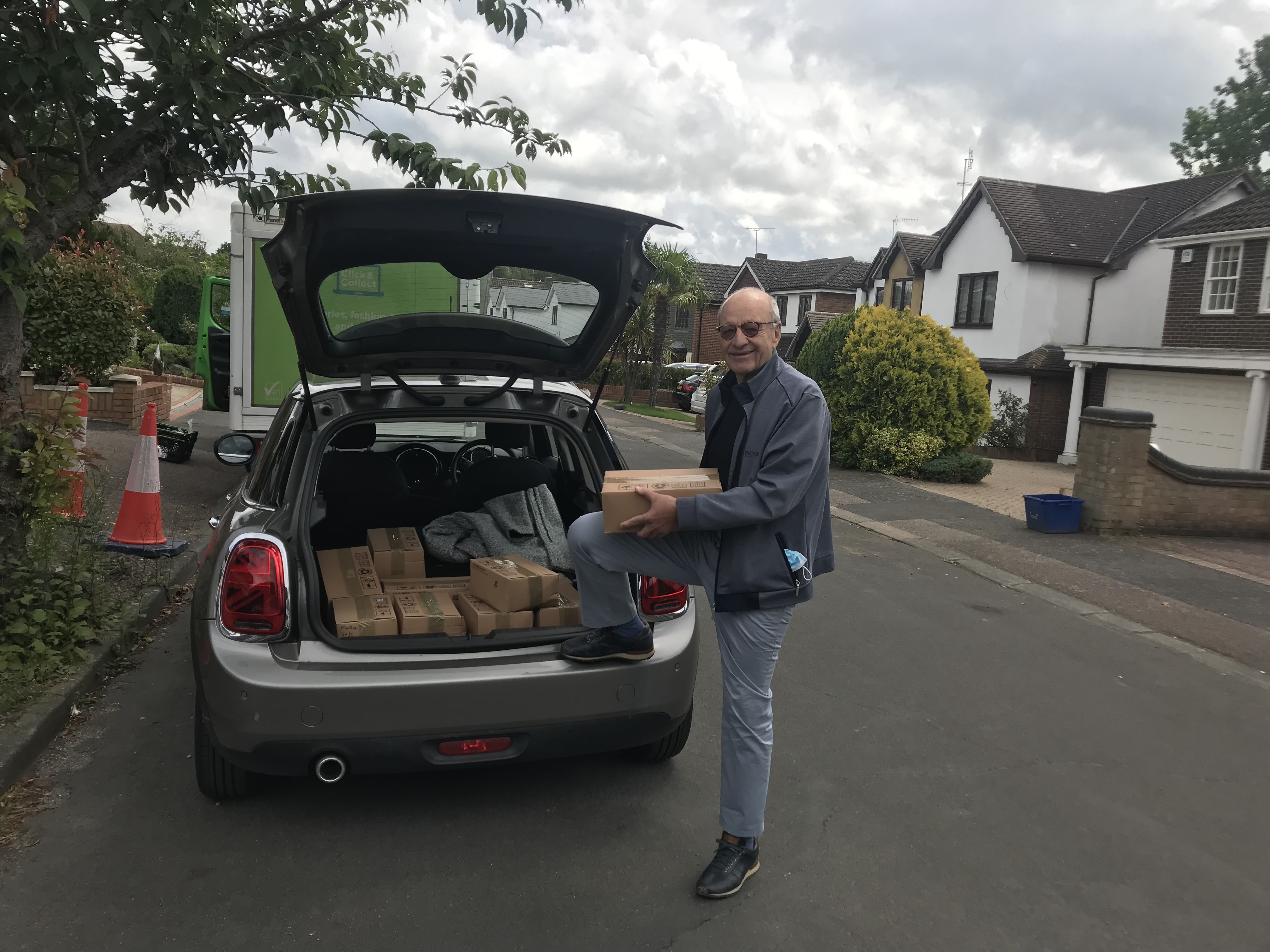 Rotarian George picks up boxes of chocolates donated by M&Ms