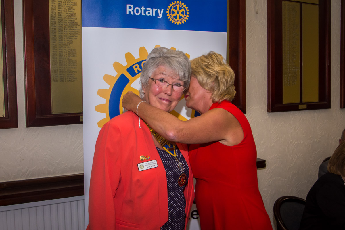 Club Assembly. - Bernadette hands over the chain of office to Linda.