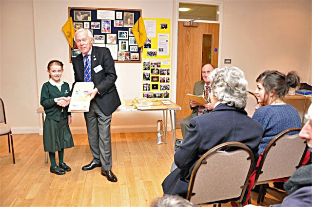 27 January 2011 - Christmas Story Competition winners receive their prizes - Amelie Brown of Heatherton House receives her prize from Chalmers Cursley, President of Amersham Rotary Club. Amelia won 1st Prize in the Years 2 & 3 category.