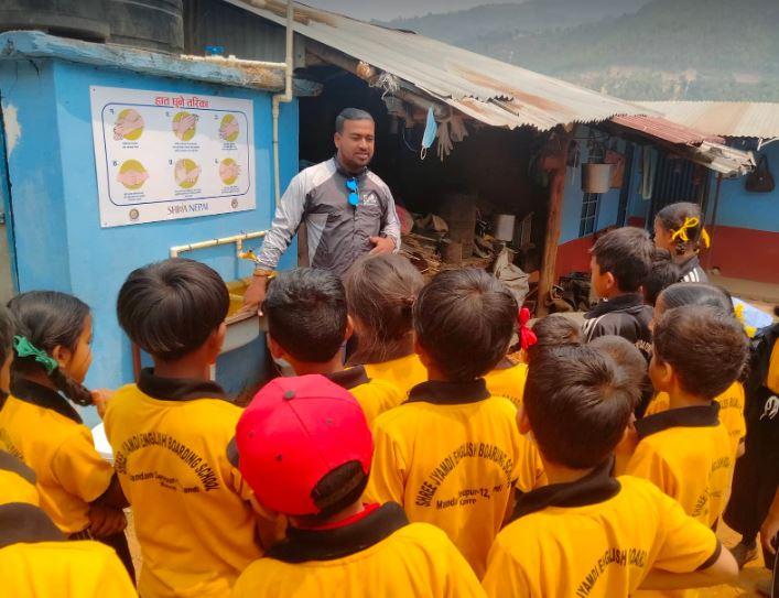 Nepal Project for clean water - The teacher talks to pupils on the correct way to wash there hands  