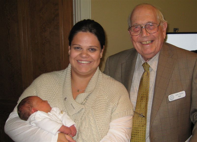 CHARLOTTE BETH EISEN - Charlotte, at six days old, with Sale's oldest member, 87 year-old John Taylor