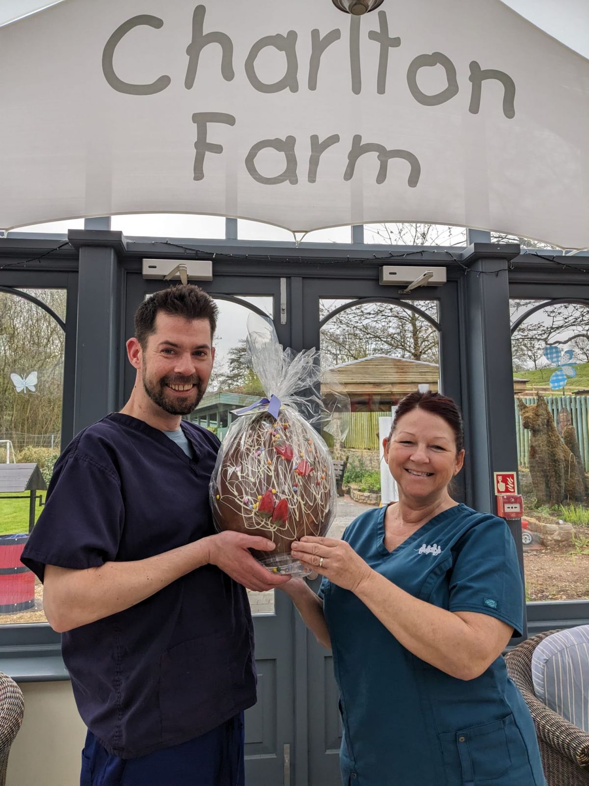 Charity Easter Egg Raffle 2023 - Ashley and Sarah accepting egg which was donated by Julie and Colin from Glynn solicitors
