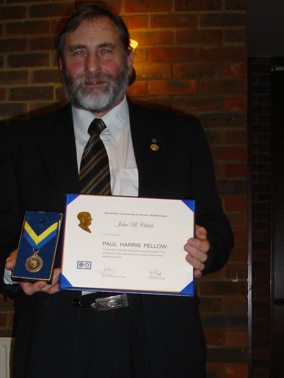 For he's a jolly good fellow - John proudly holding his Paul Harris Fellowship certificate