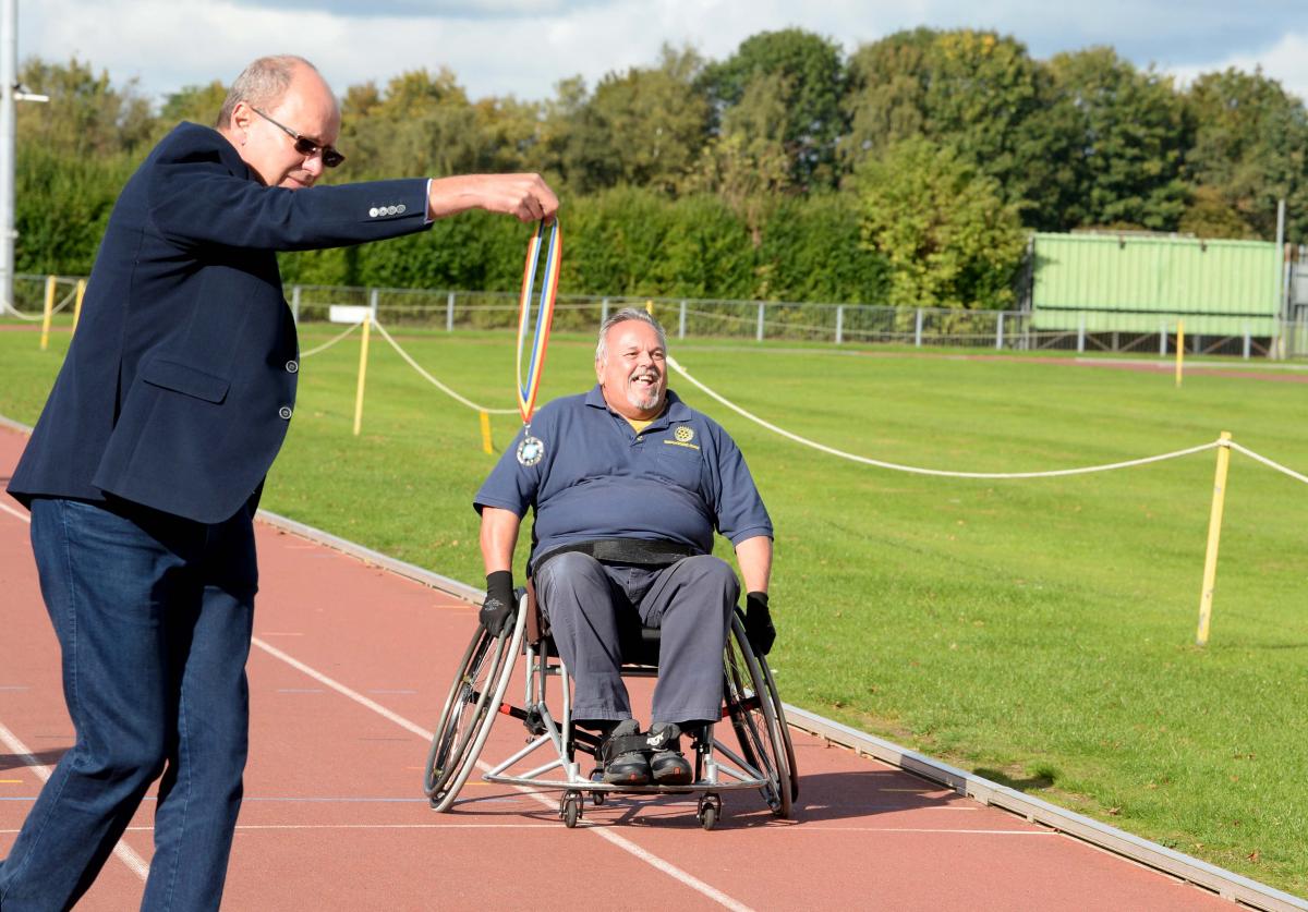 Joint Rotary Clubs Success with “Push4IT” Wheelchair Racing - Is this the fastest Ford on the track? The lure of the medal being held by Deputy Lieutenant Nick Kier is the incentive.