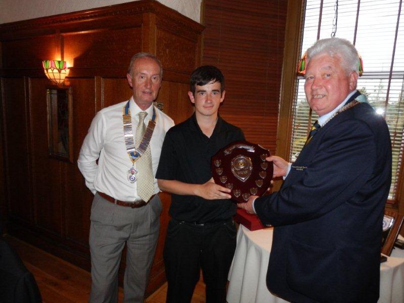 Rotary Year 2012-13 - DG John Barbour presents the winner's trophy Stuart Knox, Rotary Junior Golfer of the year