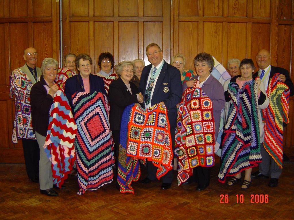 From Burbage WI - Blankets With Love - D1050 DG Michael Barker accepts the batch containing the 100th blanket.