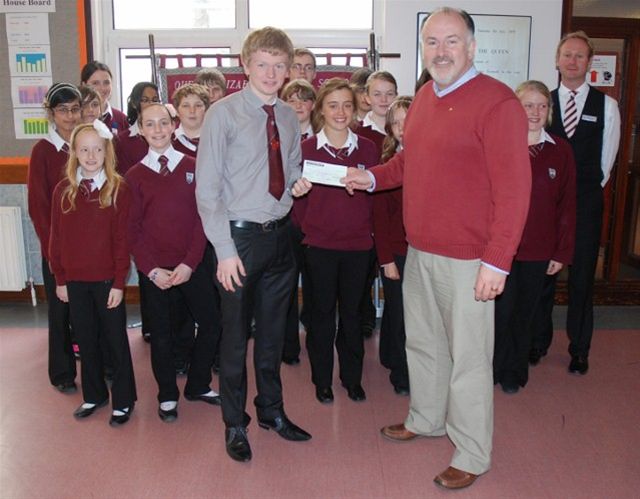 End Polio Now - Rotarian Kevin Kneen receiving a cheque from the pupils of Queen Elizabeth II High School in Peel from their End Polio activities