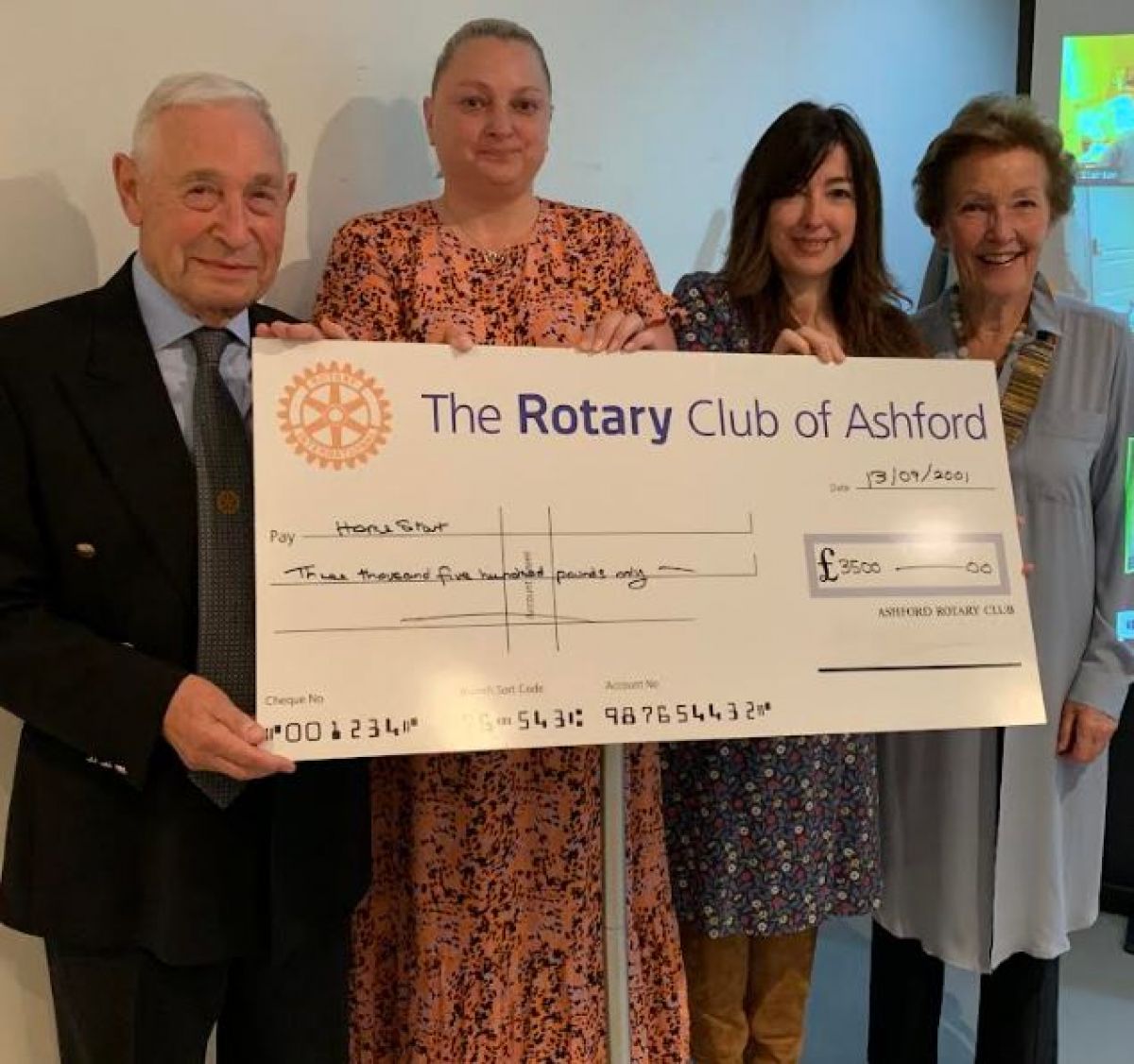 Photographs - Ashford Rotary Club - Former President Lester presents a cheque from the Club to representatives of 'HomeStart', a local charity.