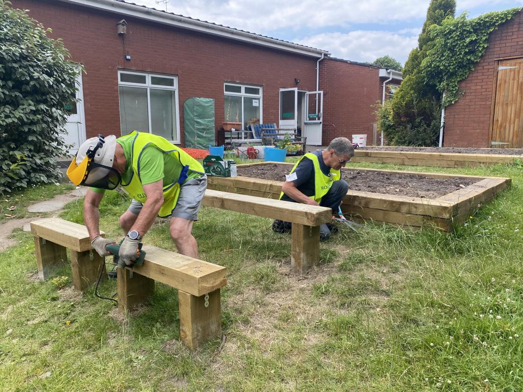 Heswall Primary School -butterfly garden  - Mid Wirral members preparing wood for raised bends and benches 