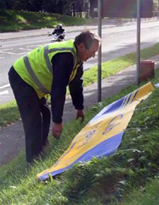 Focus on the crocus - Putting out the Rotary banner whilst planting is underway