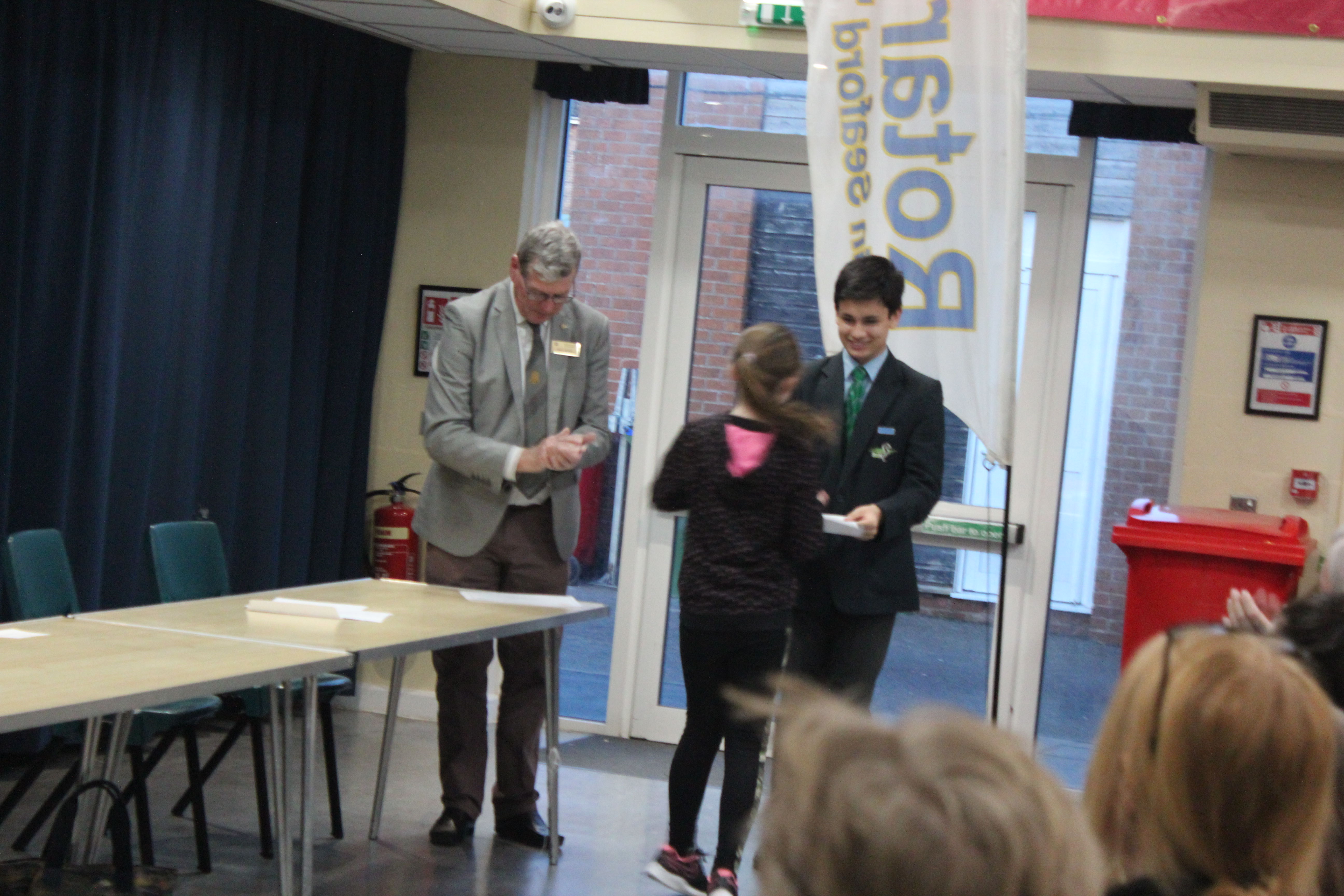 Young Writers Competition 2019 2020 - Young Mayor James Jenkins presents award to competitor with Rotarian Paul Vaesen