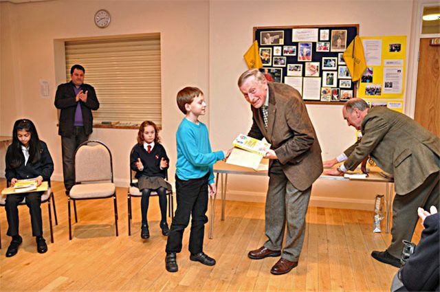 27 January 2011 - Christmas Story Competition winners receive their prizes - James Perks of Chalfont St Peter C or E School receives his prize from David Allen, President of Chesham Rotary Club. James was 2nd in the Years 4 & 5 category.