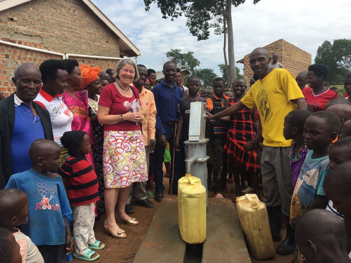 Success stories from Mubende - Bernard demonstrating the new 10,000 liter underground water tank at Kitalemwa Primary School