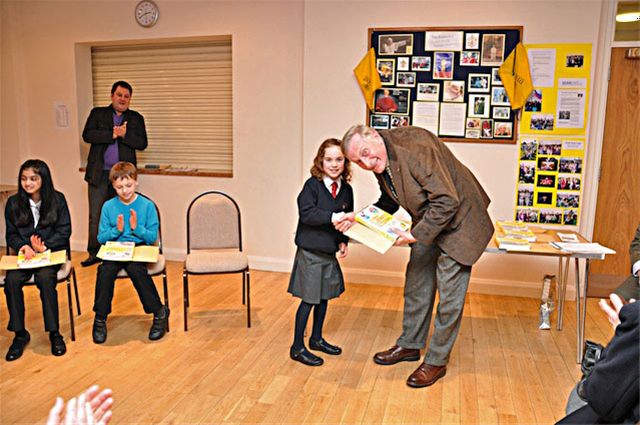 27 January 2011 - Christmas Story Competition winners receive their prizes - Lara Hill of Chalfont St Peter C of E School receives her prize from David Allen, President of Chesham Rotary Club. Lara won 1st Prize in the Years 4 & 5 category.