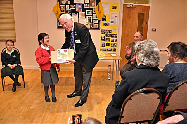 27 January 2011 - Christmas Story Competition winners receive their prizes - Martha Wright of Little Kingshill C of E School receives her prize from Chalmers Cursley, President of Amersham Rotary Club. Martha was 3rd in the Years 2 & 3 category.