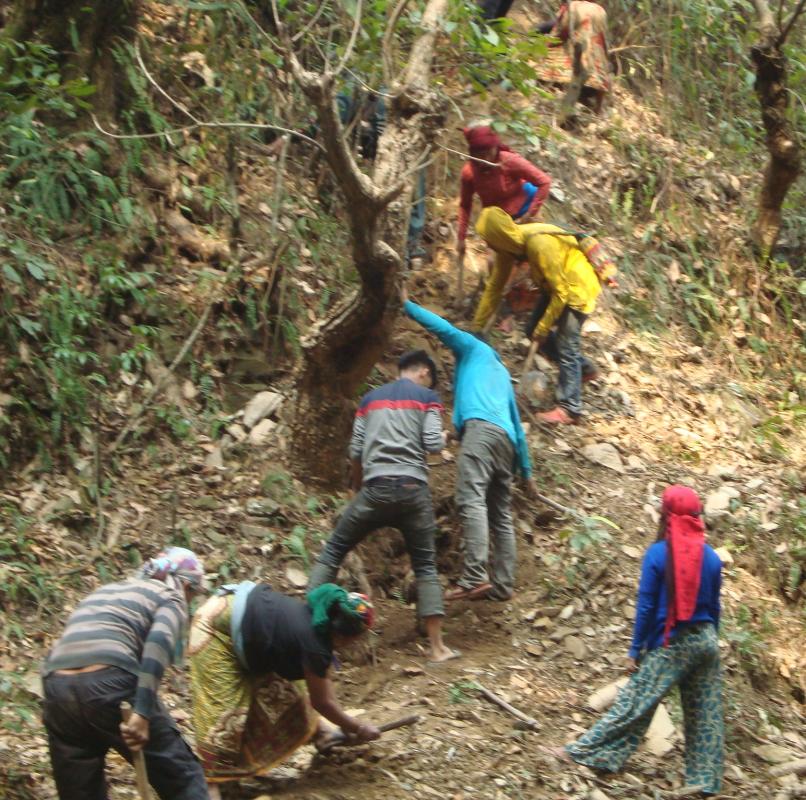 Nepal Water Project Completion Report - Locals dig tunnelto lay pvc pipes in them 