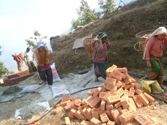 Nepal Water Project Completion Report - Local women help to transport bricks and concrete mix to the Project site