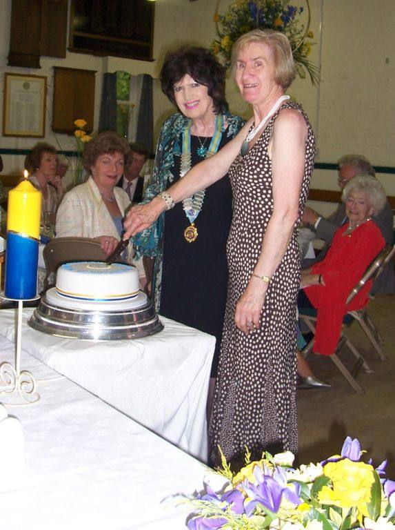 Inner Wheel 50th Charter Celebrations - Barbara Densem, the newest member cutting the Cake with the District Chairman