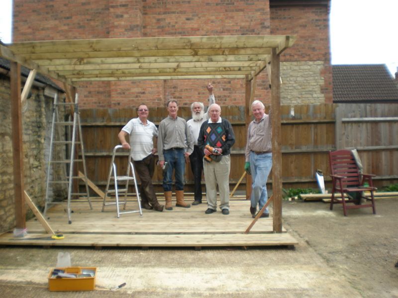 Oakfield's Homestead - The first view of the frame of the pergola, whcih Chris likes to term as a 'pagoda'. Chris, Roger G, Norman, Peter and Roger B (who seems to be propping it up)