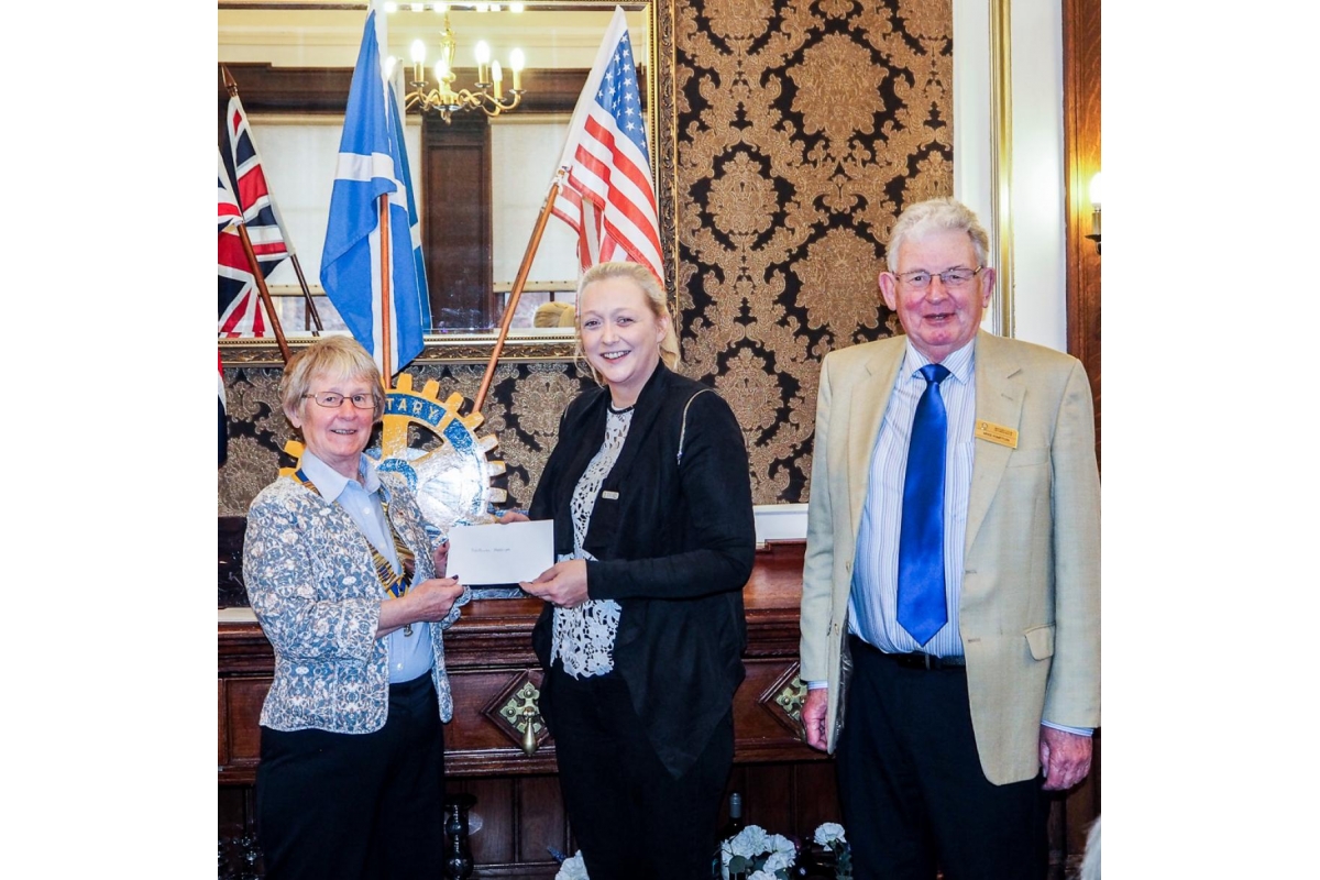 Annual Charity Disbursements - Cheque presentation to Cara Ingles for MacMillan Nurses by President Ann and Rotarian Mike
