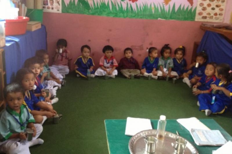 International Service - Nepalese children enjoying their daily mug of milk at the Pegasus School
