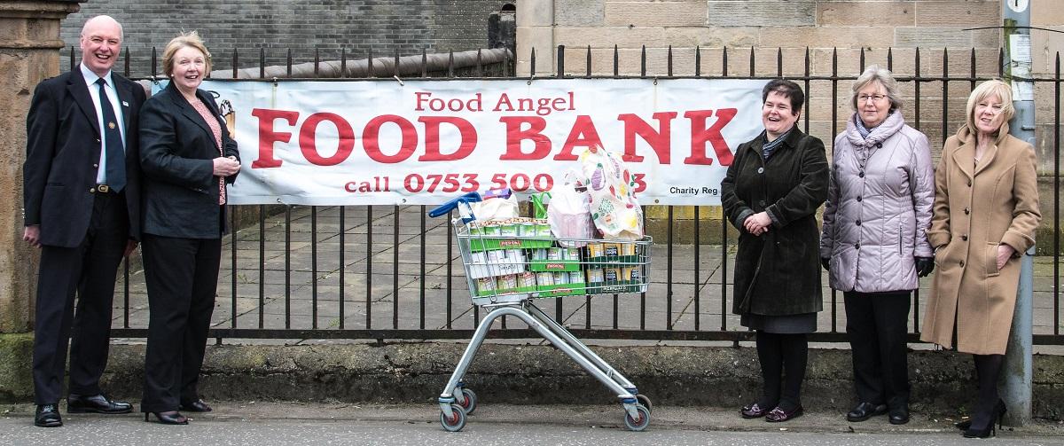 Rotarians donate to the URC Food Angel Foodbank - Rtn. Mike Kimpton stopped the traffic in Port Glasgow to take this photo