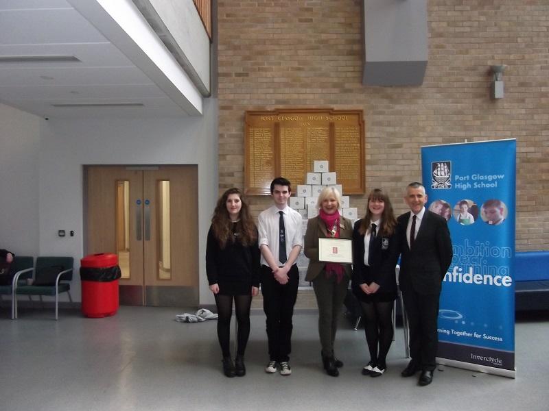 2014 Shoebox Project - President Anne presents a certificate to Port Glasgow High School students.